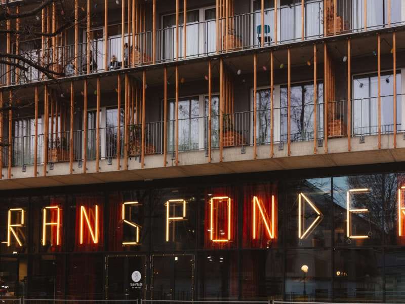 The Transponder's neon sign on the Superbude facade